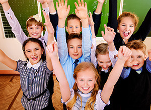 stock-photo-happy-schoolchildren-at-a-classroom-education-209458519